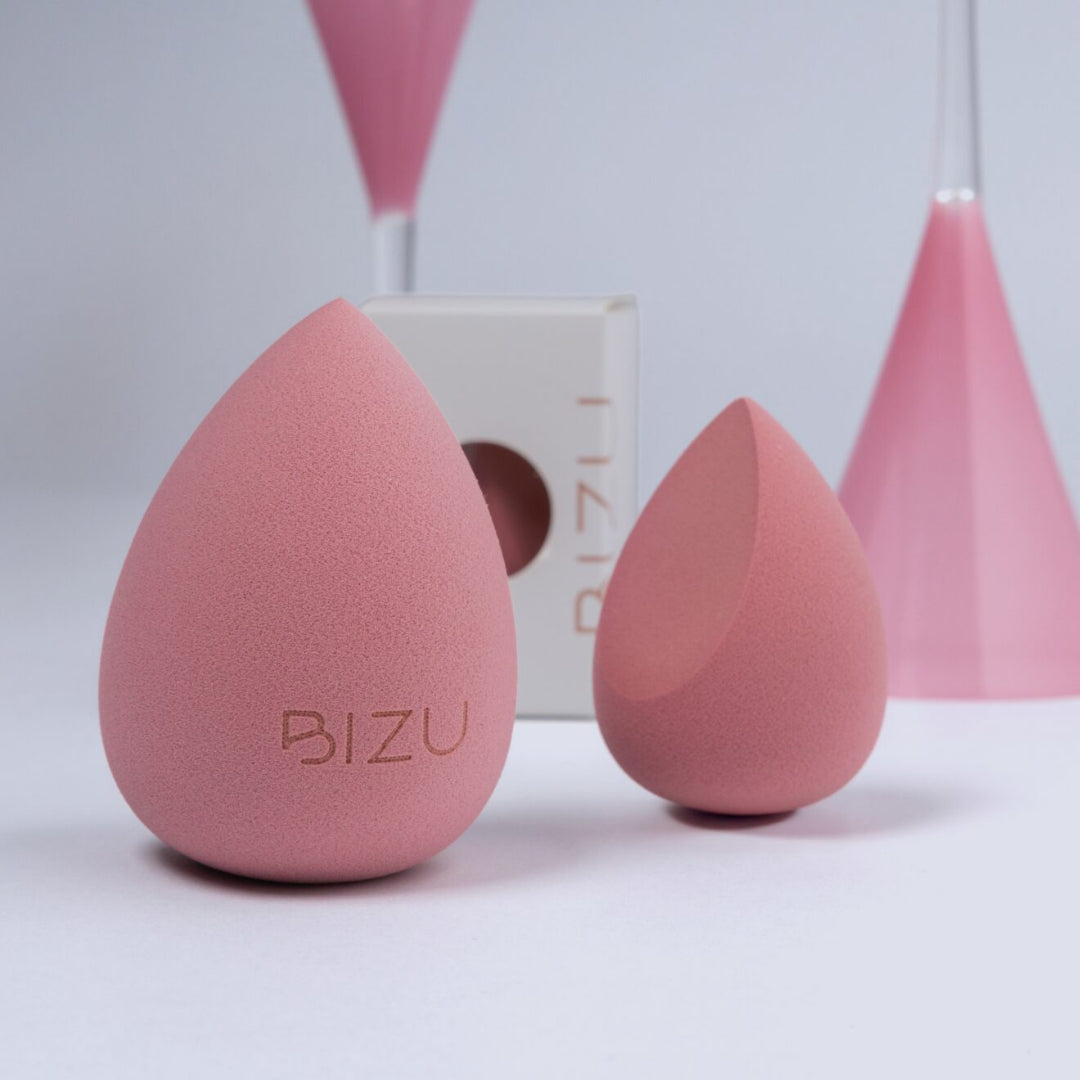 Pink makeup sponges with 'BIZU' branding on a light gray background